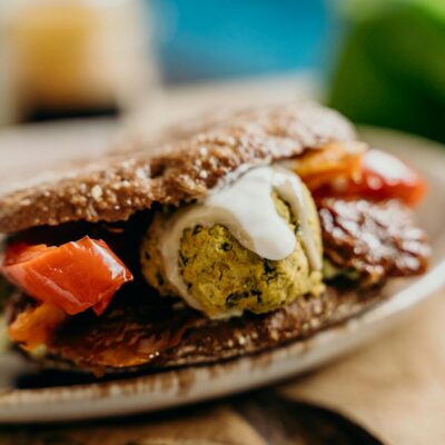 Brown Bread With White Cream and Red Sauce on White Ceramic Plate